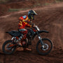biker on dirt road during daytime