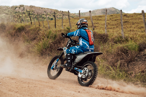a person riding a dirt bike on a dirt road