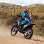 a person riding a dirt bike on a dirt road