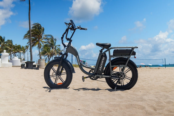 An electric bike parked on a beach near palm trees