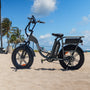 An electric bike parked on a beach near palm trees
