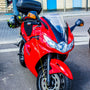 A red motorcycle parked on the side of the road