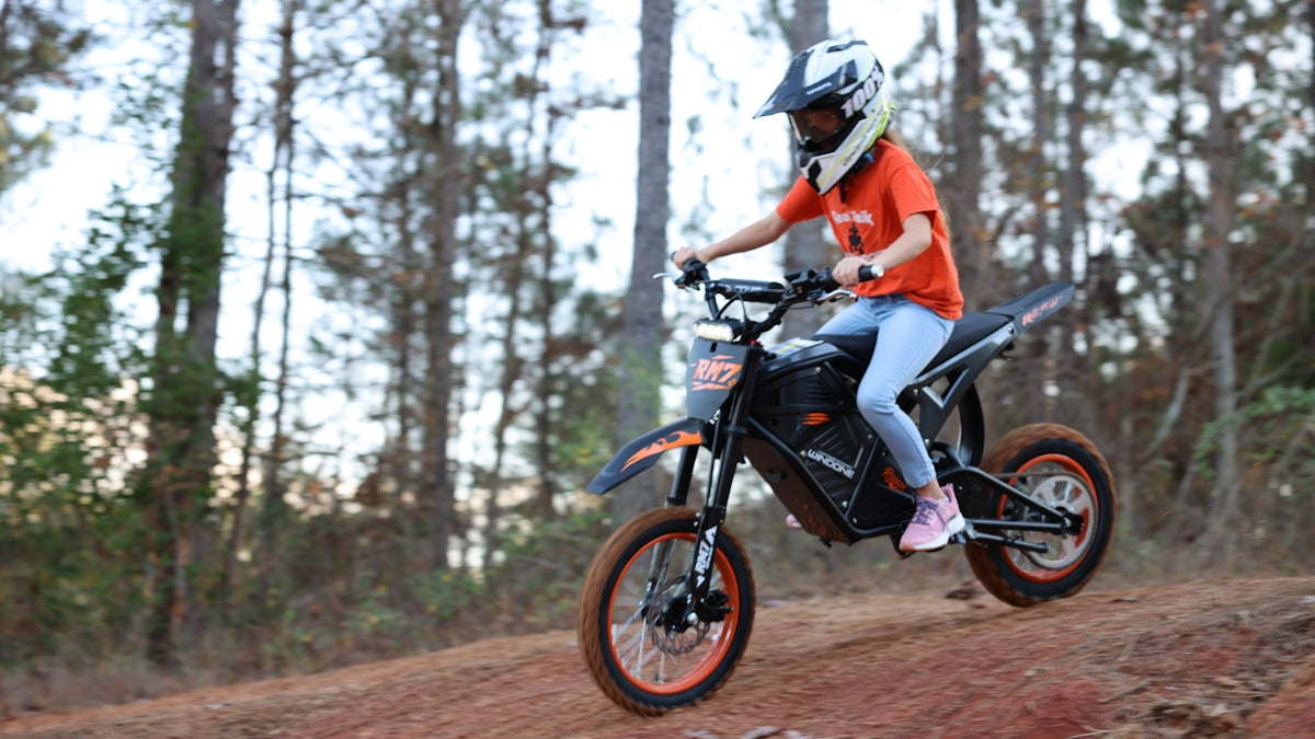 Woman riding a dirt bike on a trail