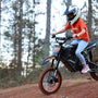 Woman riding a dirt bike on a trail